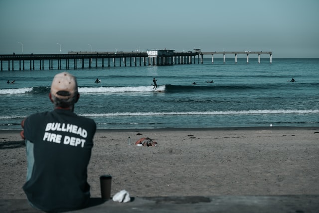 San Diego firefighter on the beach watching people surf