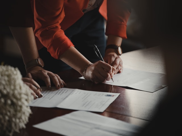 Two people signing divorce papers with a family lawyer near Chula Vista, California