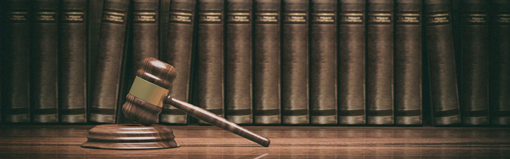 gavel in front of a row of law books