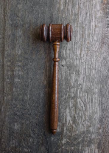 A judge’s gavel on a dark wood table