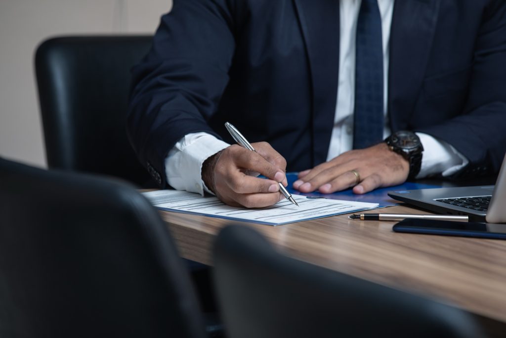 lawyer writing in office with pen