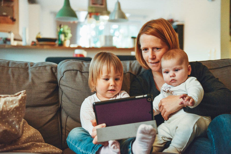Woman with two children on a tablet