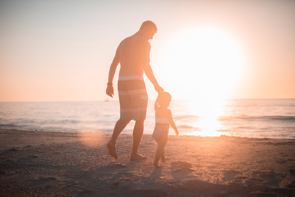 Father with toddler on a beach in California after establishing paternity post-divorce