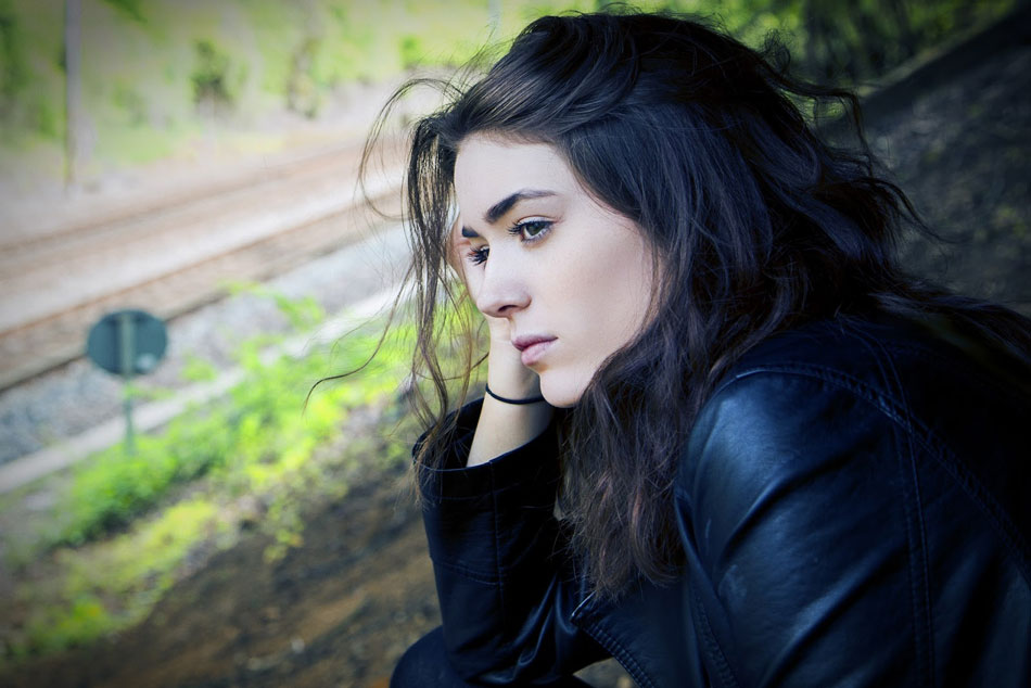 woman feeling sad looks out window