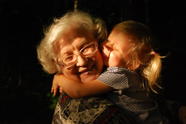 Grandmother and granddaughter embracing and smiling