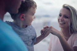 Woman showing a child her engagement ring